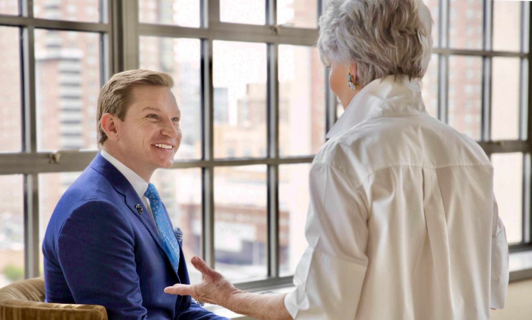 Brendan Hart speaking with a participant at an institutional event